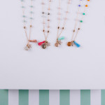 Wholesale short blush beaded necklace star accent fanned tassel